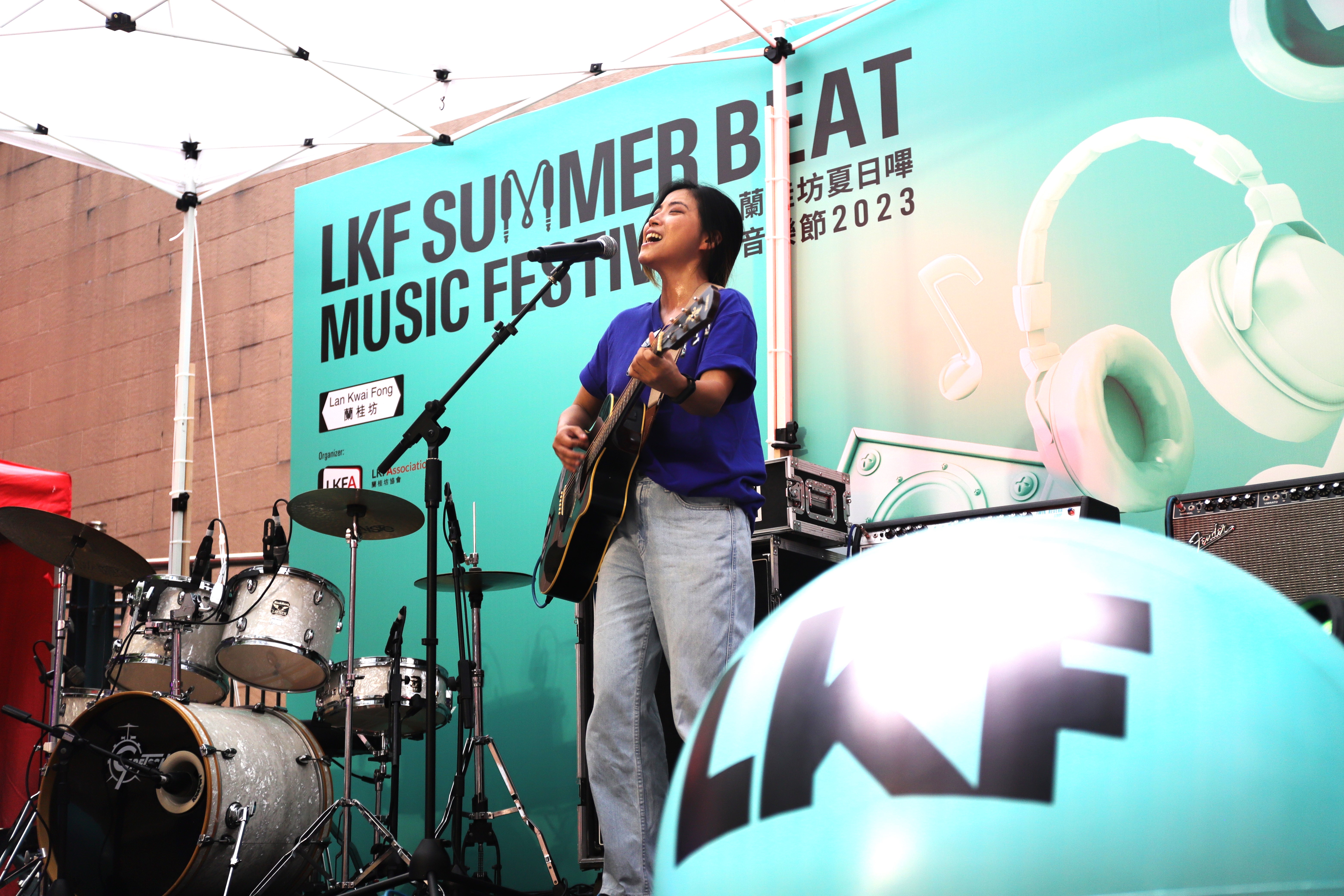 Festival-goers groove to the infectious beats, igniting the dance floor with their energetic moves during the LKF Summer Beat Music Festival 2023 in Lan Kwai Fong